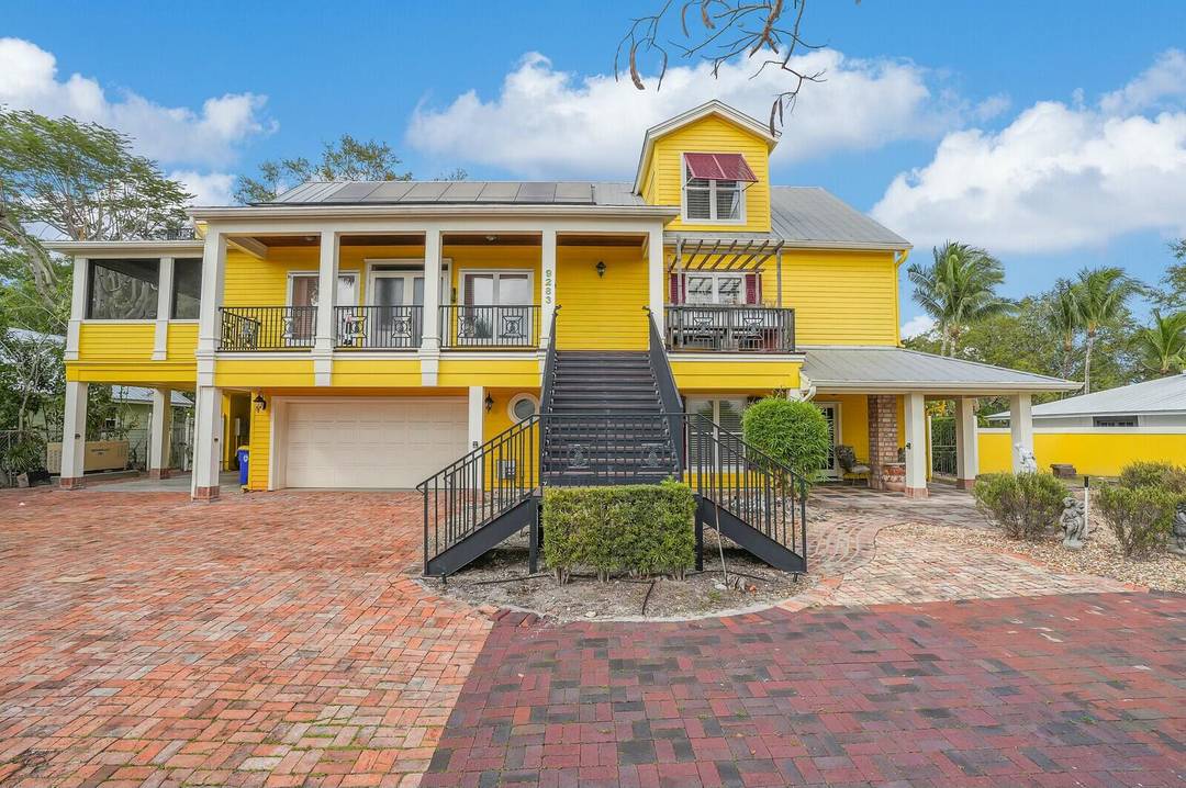 This timeless three story waterfront home features strong poured concrete construction with five beds and four baths, designed in British French Colonial style on a spacious 15, 000 sf lot.