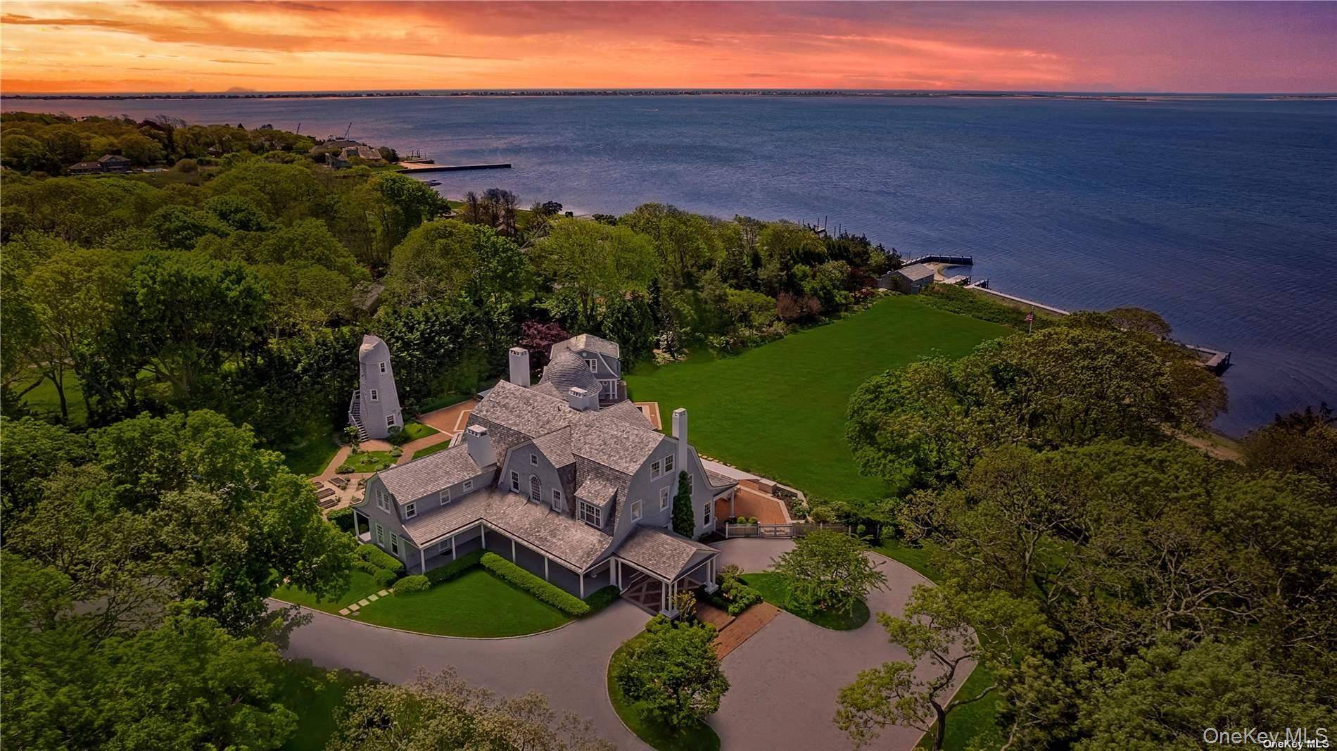 This majestic, one of a kind estate is set on 4 private, resort like acres south of Montauk Highway.