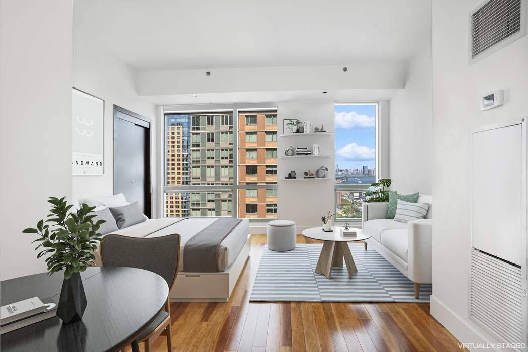 High floor oversized studio with Manhattan skyline views at The Toren in Downtown Brooklyn.