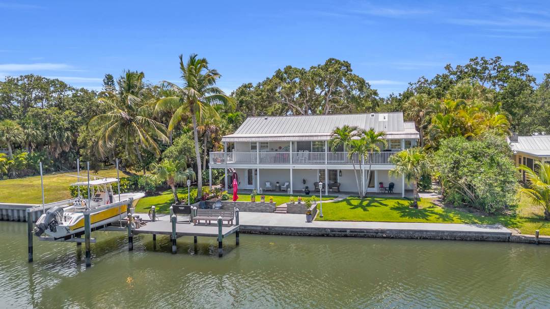 Wake up to daily dolphin manatee sightings from your backyard at this unique riverfront home, complete with a private dock, 12, 000 lb boat lift, and newly refinished seawall !