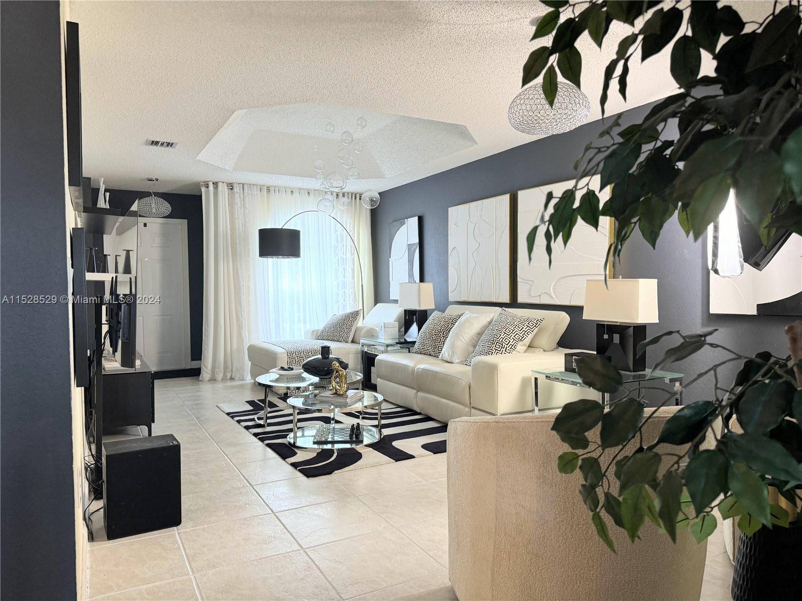 Step into the charm of this beautiful, elegant, and meticulously upgraded townhouse at Doral Landings.