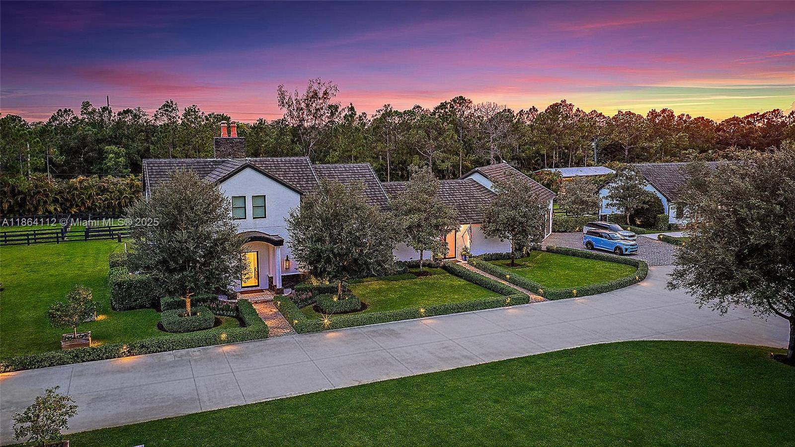 This completely reimagined estate combines timeless charm with modern luxury on 5 private acres in Palm Beach Gardens' coveted equestrian community of Caloosa.