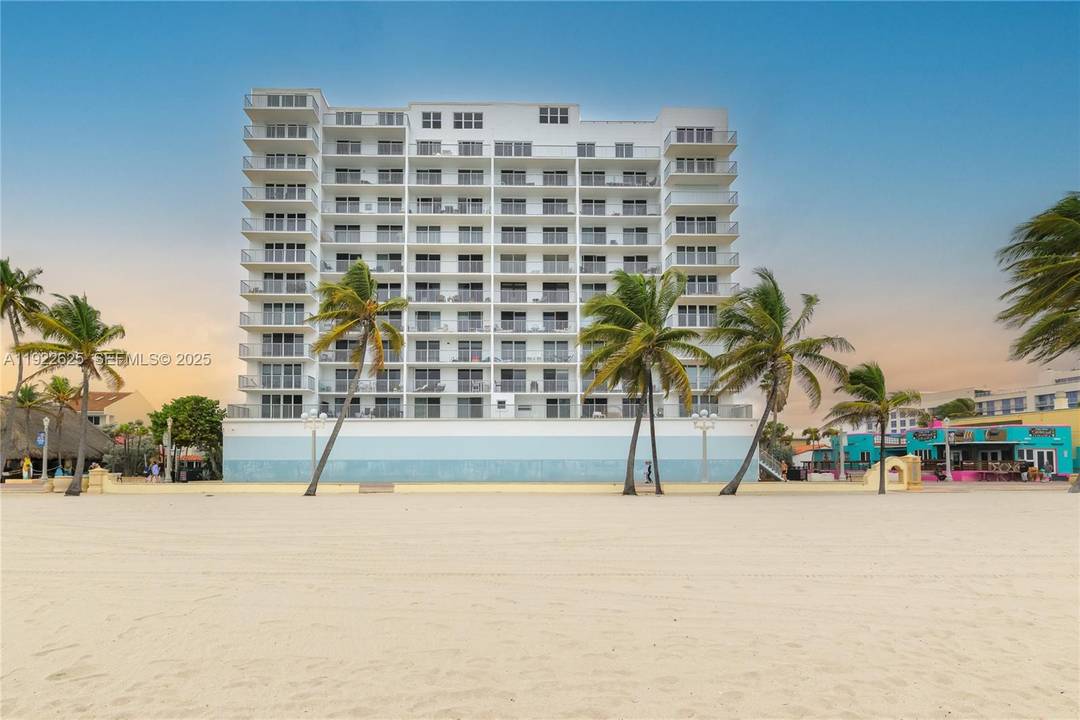 Stunning 2 bedroom, 2 bath corner unit on the Hollywood Beach Boardwalk featuring impact windows, a private balcony, and direct ocean views.