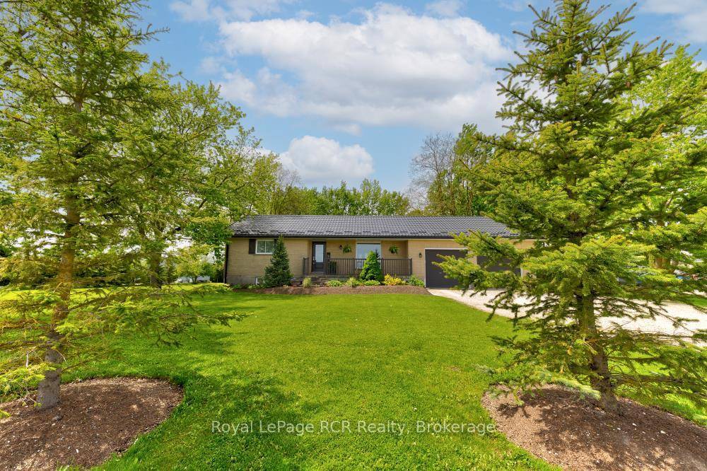 Set on a peaceful 1. 5 acre lot, this sturdy all brick 3 bedroom, 2 bathroom bungalow offers space, comfort, and efficiency.