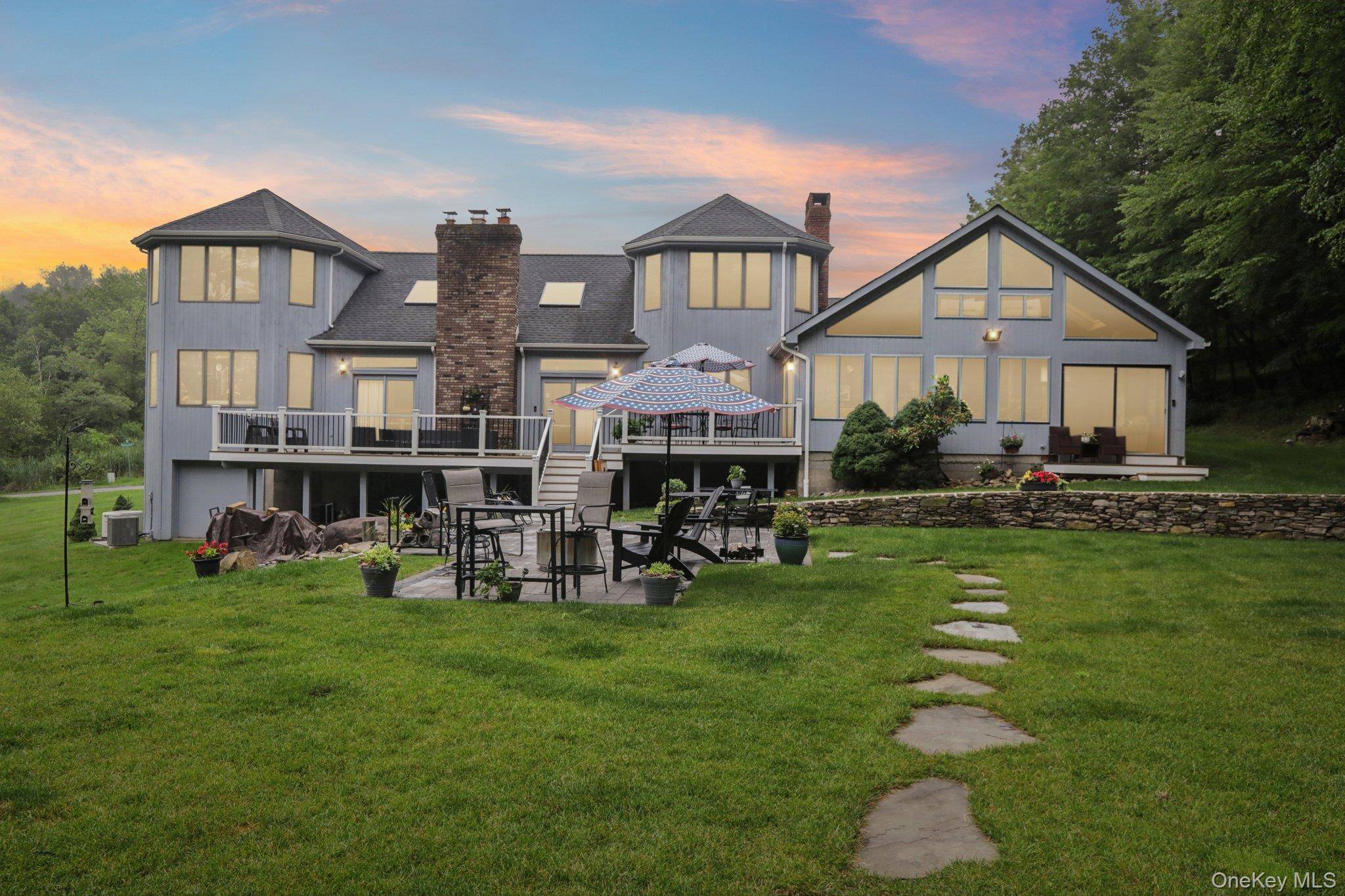 Welcome to 10 Mountain Brook Road, a magnificent contemporary home set on a lush 1.