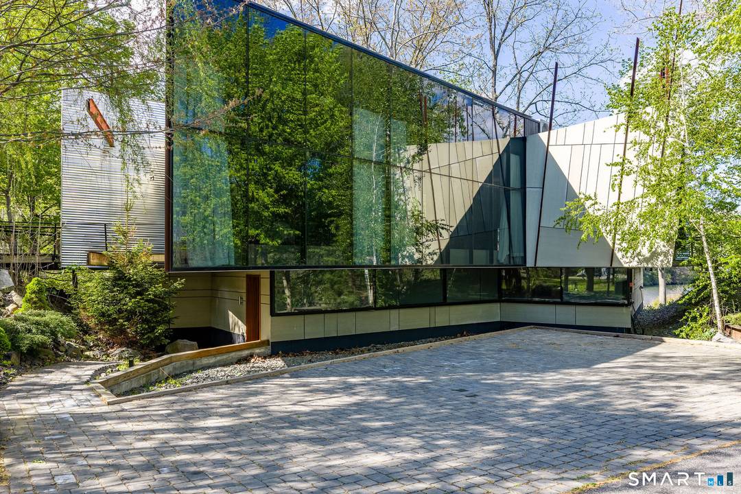 Step into summer at this incredible home, where modern design meets nature's tranquility.