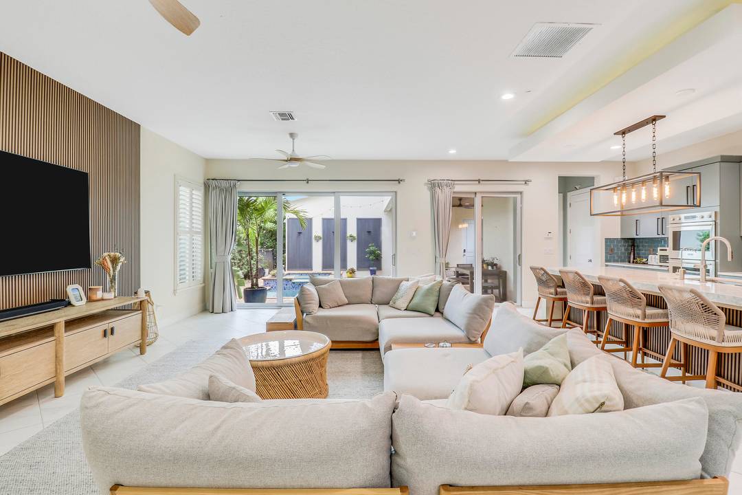 This stunning move in ready home features porcelain floors downstairs, vinyl plank floors upstairs, custom wallpaper, designer paint, light fixtures, wood slat panels, and window treatments.