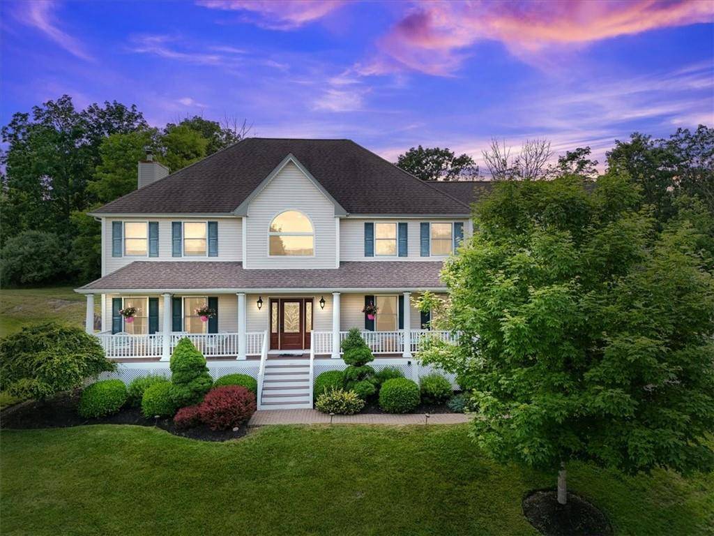 Set high above the landscape with sweeping views and breathtaking sunrises, this beautifully updated colonial style home offers over 2.