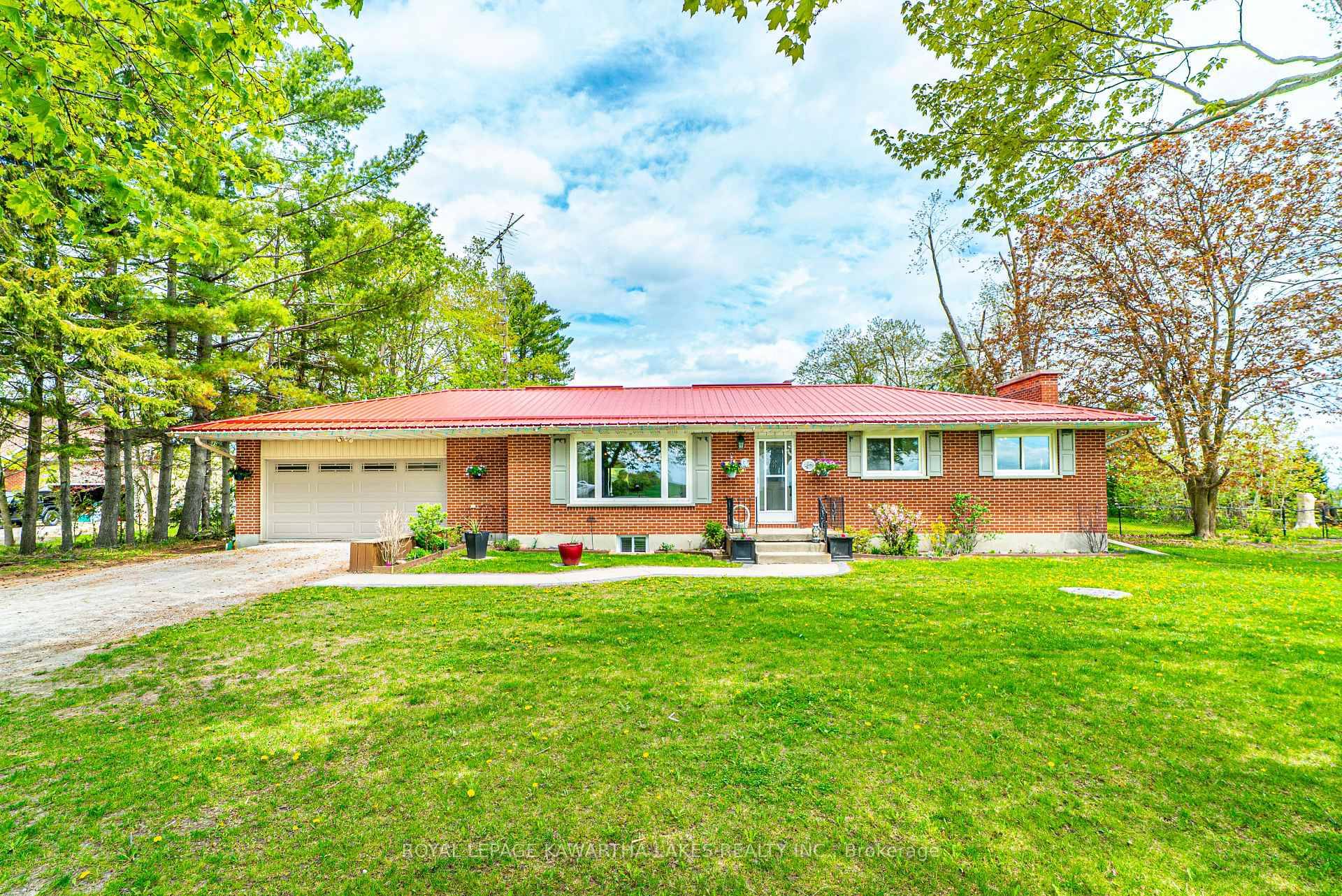 Enjoy peaceful country living just minutes from town in this spacious 4 bedroom, 3 bath brick bungalow set on a beautiful 1 acre lot.