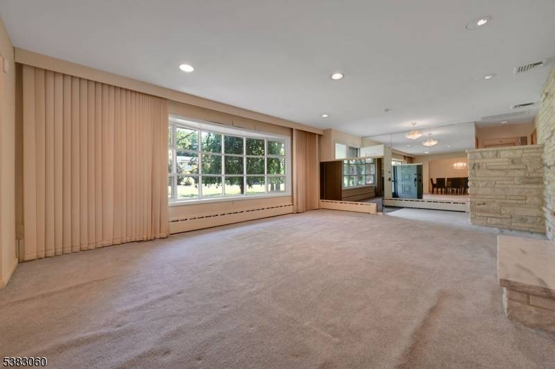 Nestled on over an acre, this three bedroom, three bath ranch offers a spacious and tranquil setting.