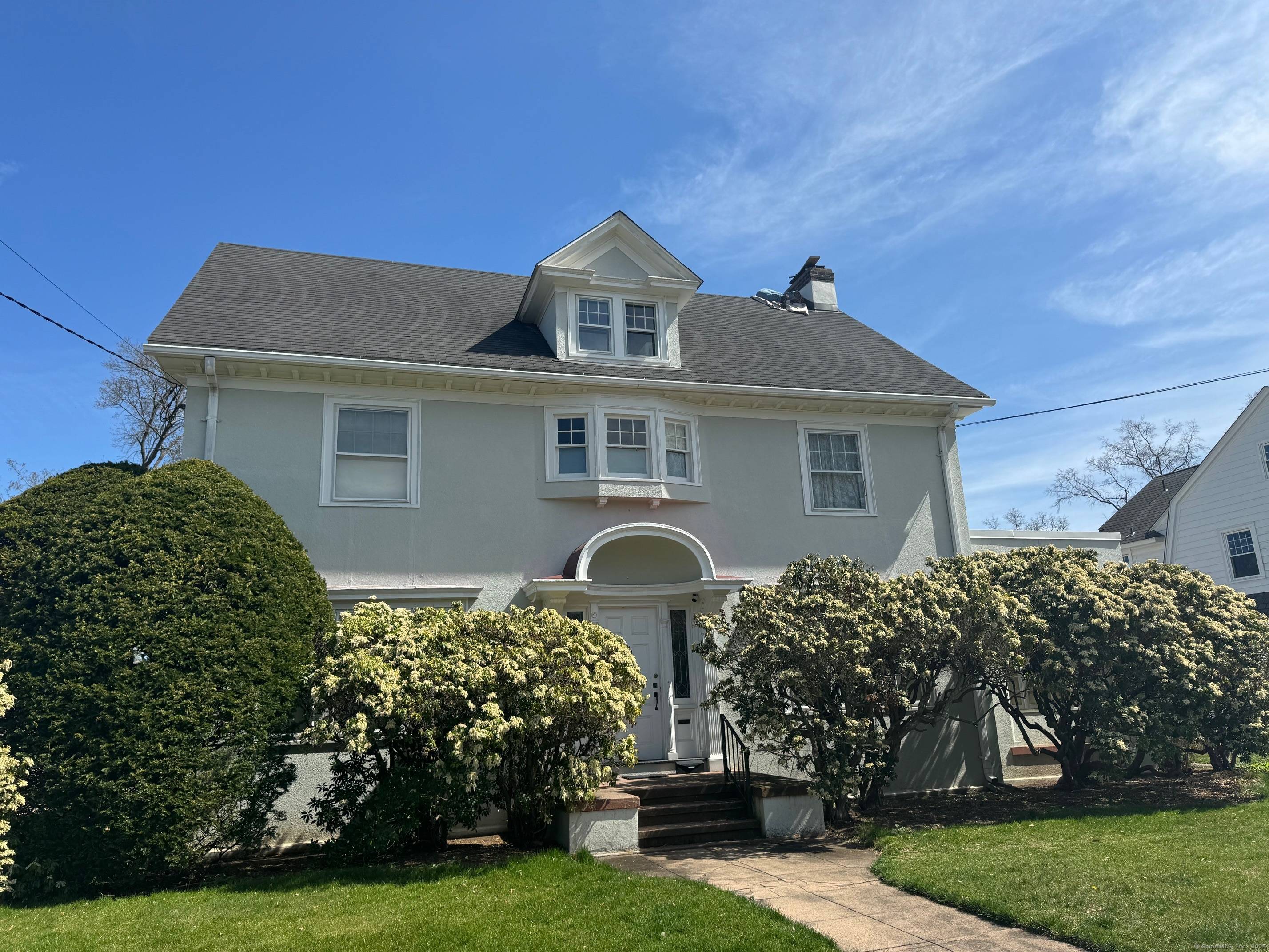 A stately, gracious light filled stucco home is located on a very desirable quiet tree lined Westville street.