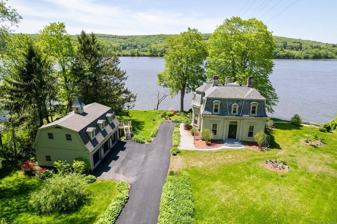 The striking David Watrous house, located on the CT river, offers unobstructed views of the river where it merges with the Salmon river from every room.