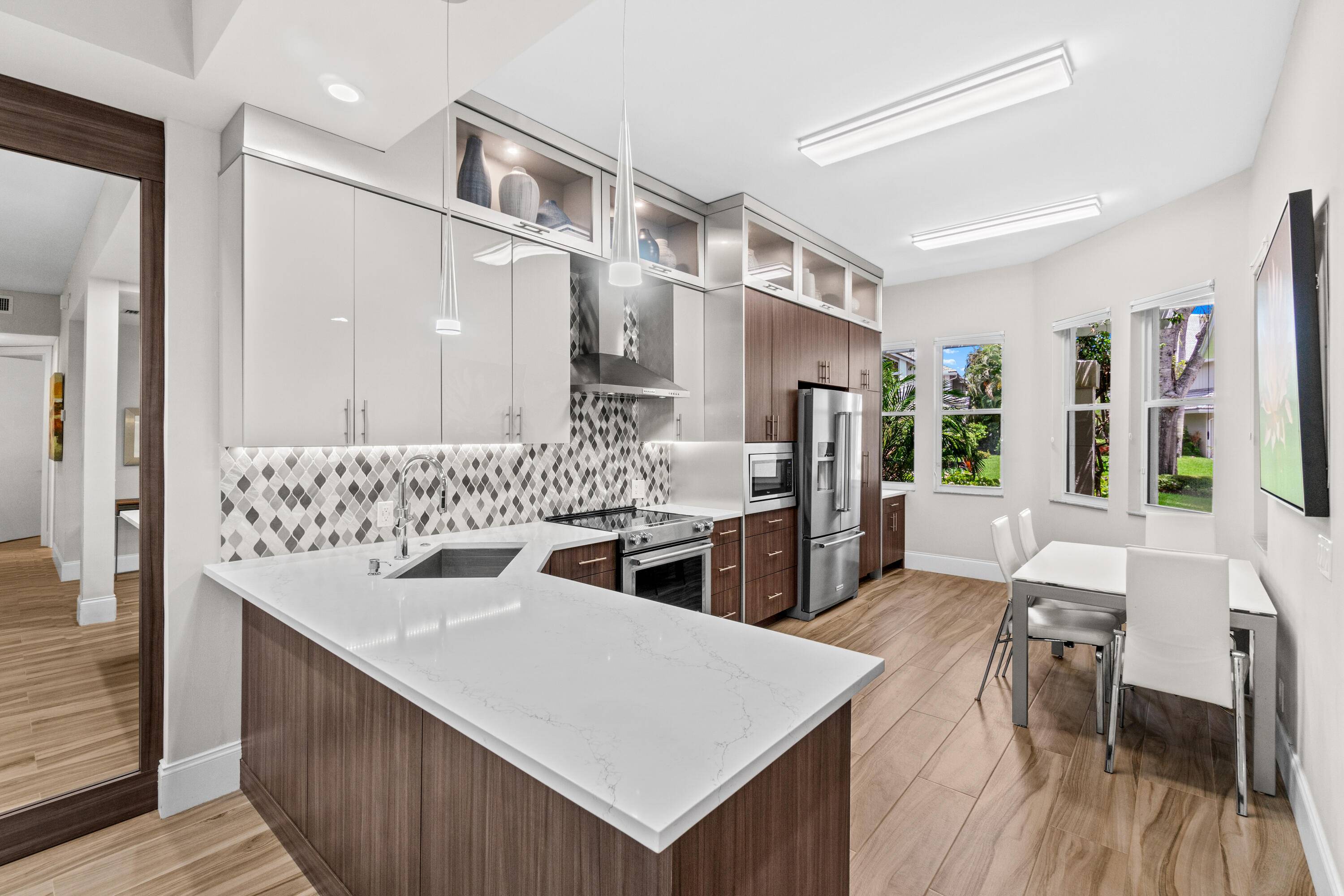 Step into this beautifully renovated, first floor condo, where sunlight fills the interior through oversized glass doors that frame picturesque golf course views.