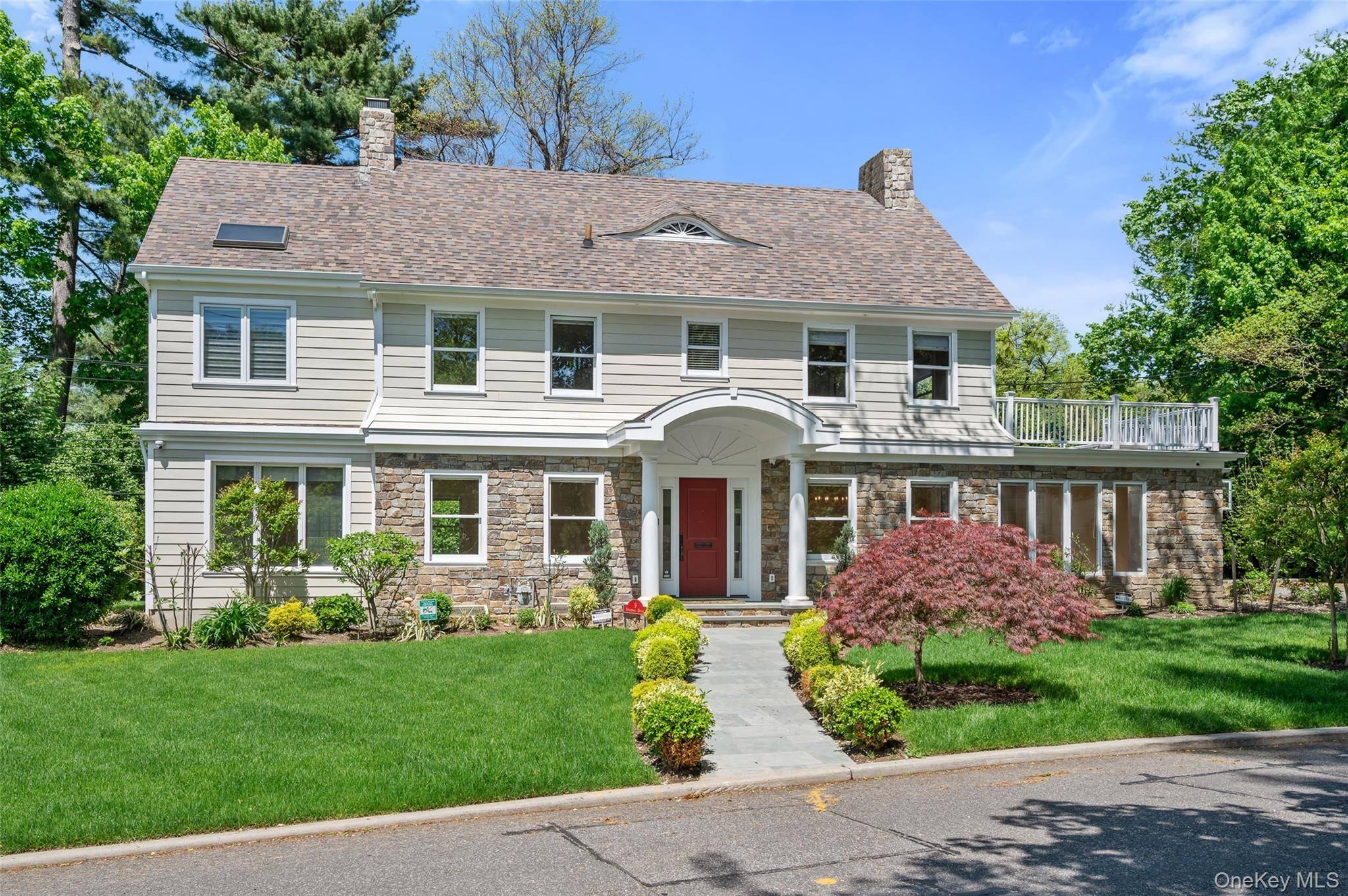Discover refined living in this distinguished Center Hall Colonial, perfectly positioned on a coveted corner lot in prestigious Great Neck Estates.