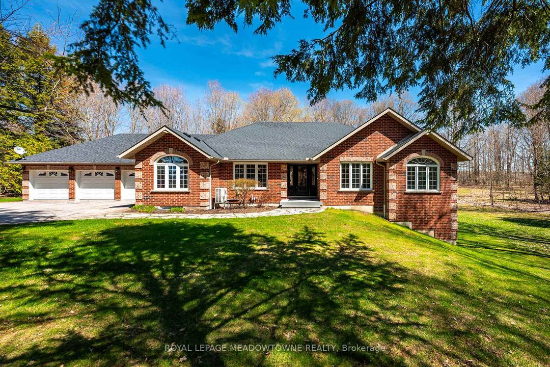 Situated on a peaceful, forested lot, this beautifully updated 4 bedroom, 4 bathroom bungalow sits on approx.