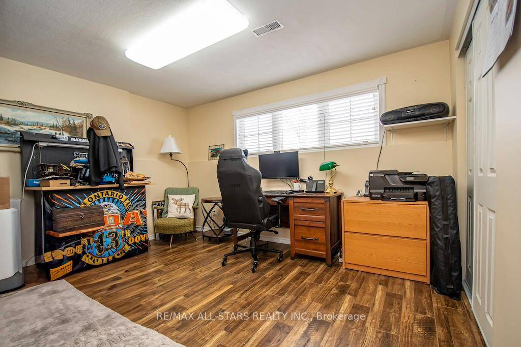 This stunning home boasts an open concept kitchen, living, and dining area with soaring cathedral ceilings and gleaming hardwood floors, while the inviting corner fireplace serves as a cozy focal ...