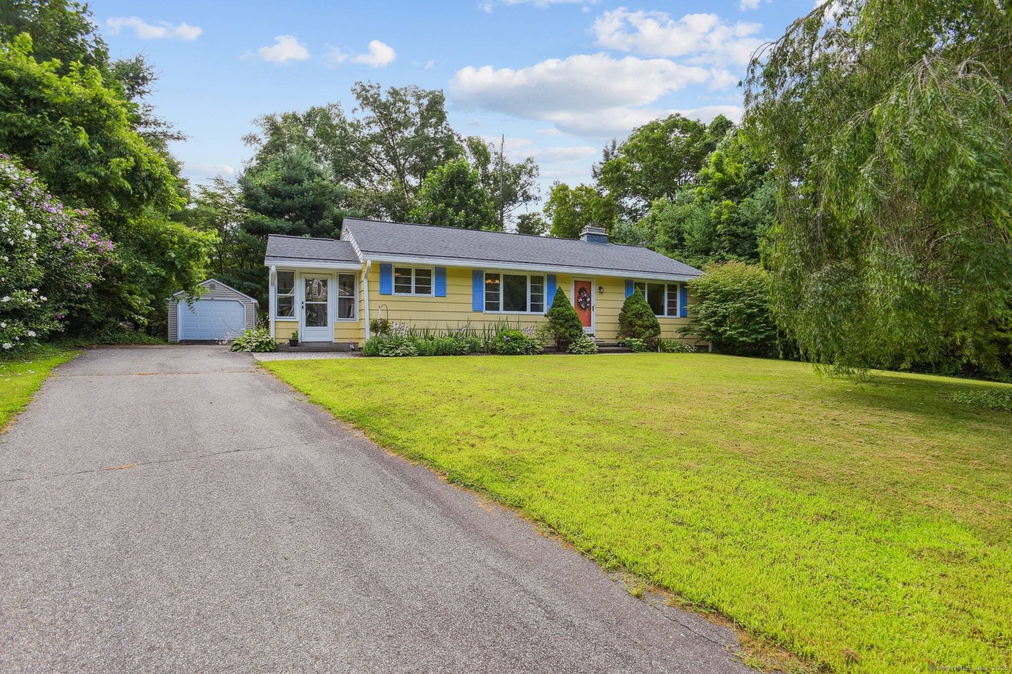 Step inside to discover a bright, open layout featuring gleaming hardwood floors, a cozy fireplace, and a cheerful sunroom ideal for unwinding or working from home.