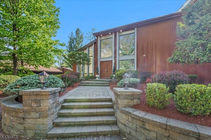 Perched on a breathtaking, view filled setting, this exceptional contemporary home blends striking architectural design with luxury updates and incredible outdoor living.