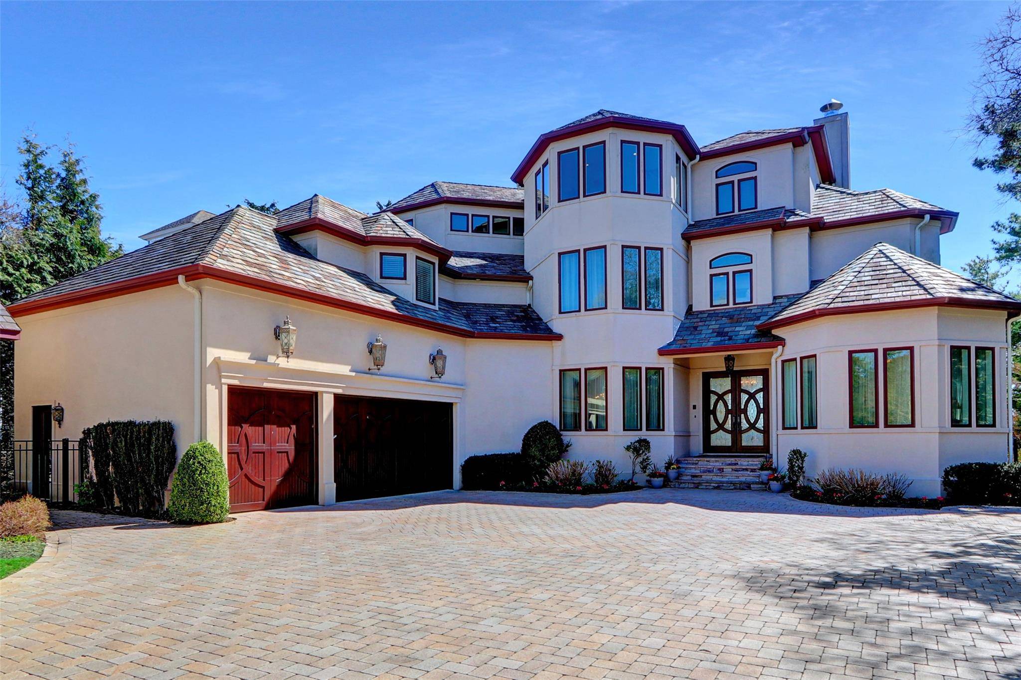 Experience luxury coastal living in this breathtaking 3 level Mediterranean style estate, perfectly positioned on the shores of Northport Bay.