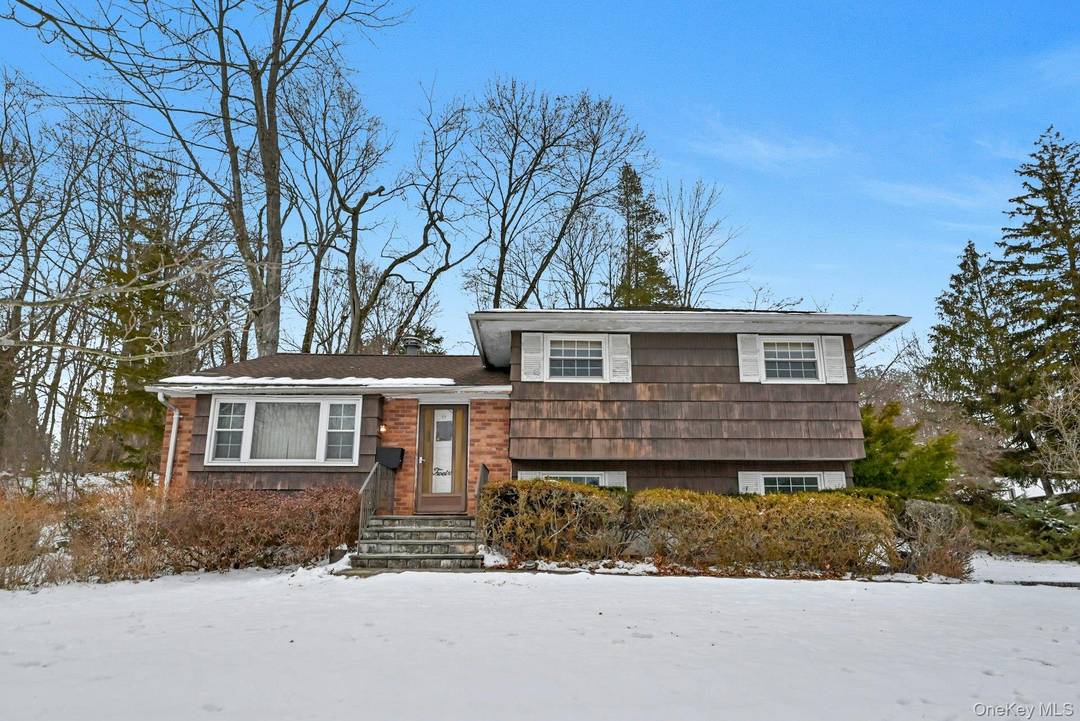 Welcome to this beautifully well maintained 3 bedroom, 2 full bath split level residence set in a desirable New City location.