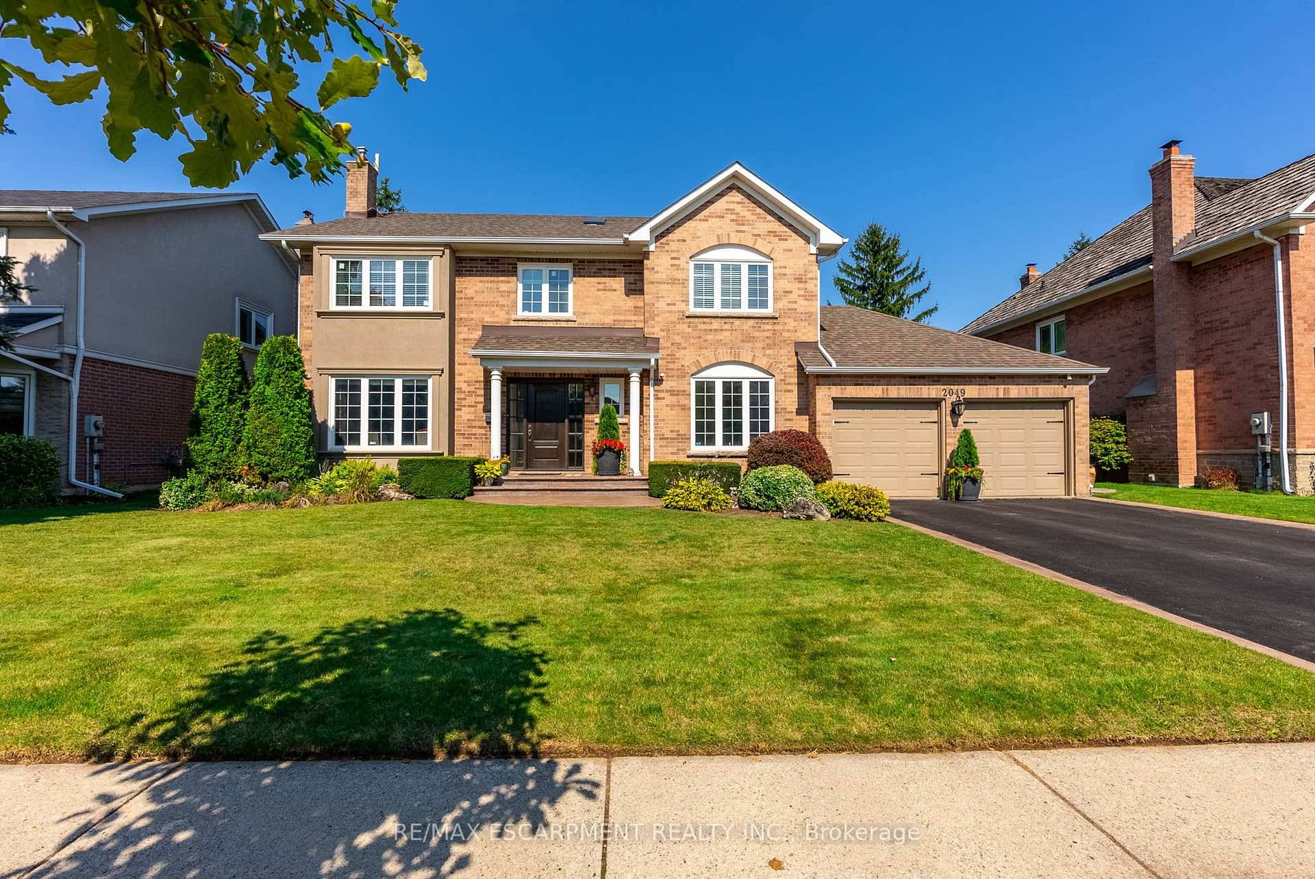 This fabulous previous model home boasts timeless curb appeal with its classic brick exterior and symmetrical design.