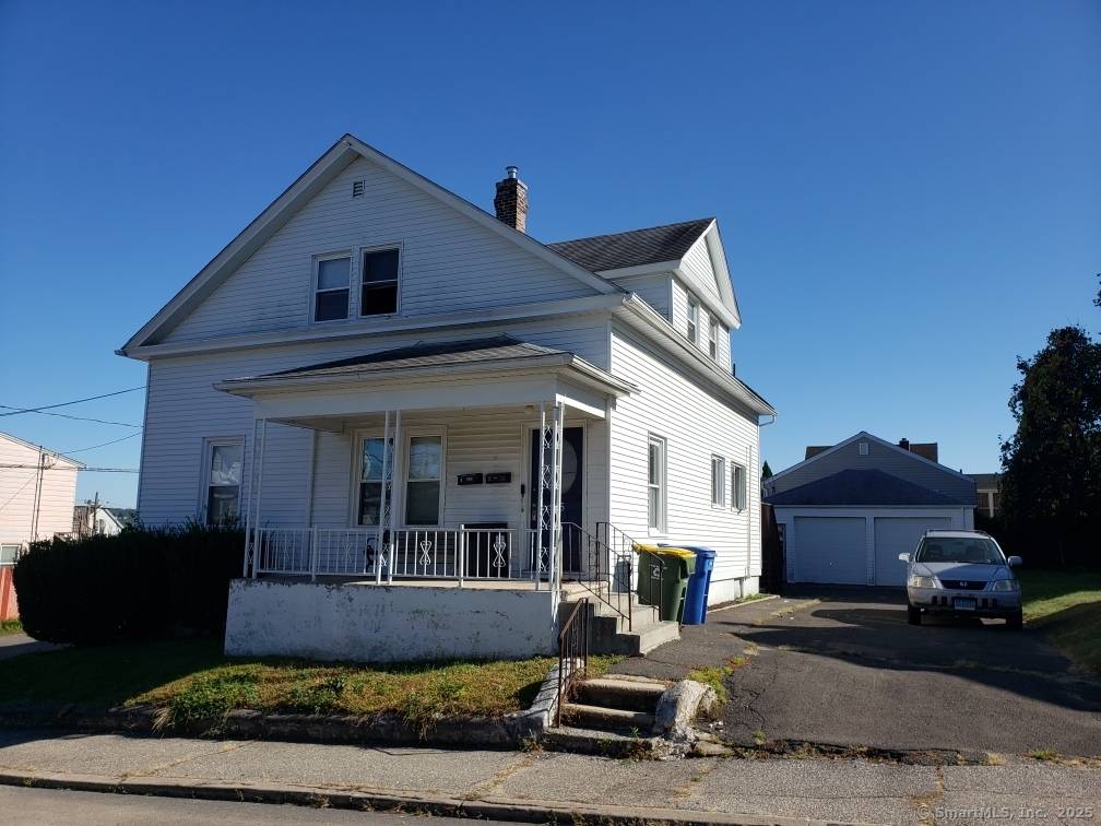 Great Multi Family Home in the heart of Town Plot with 5 detached garages for extra income and two driveways.