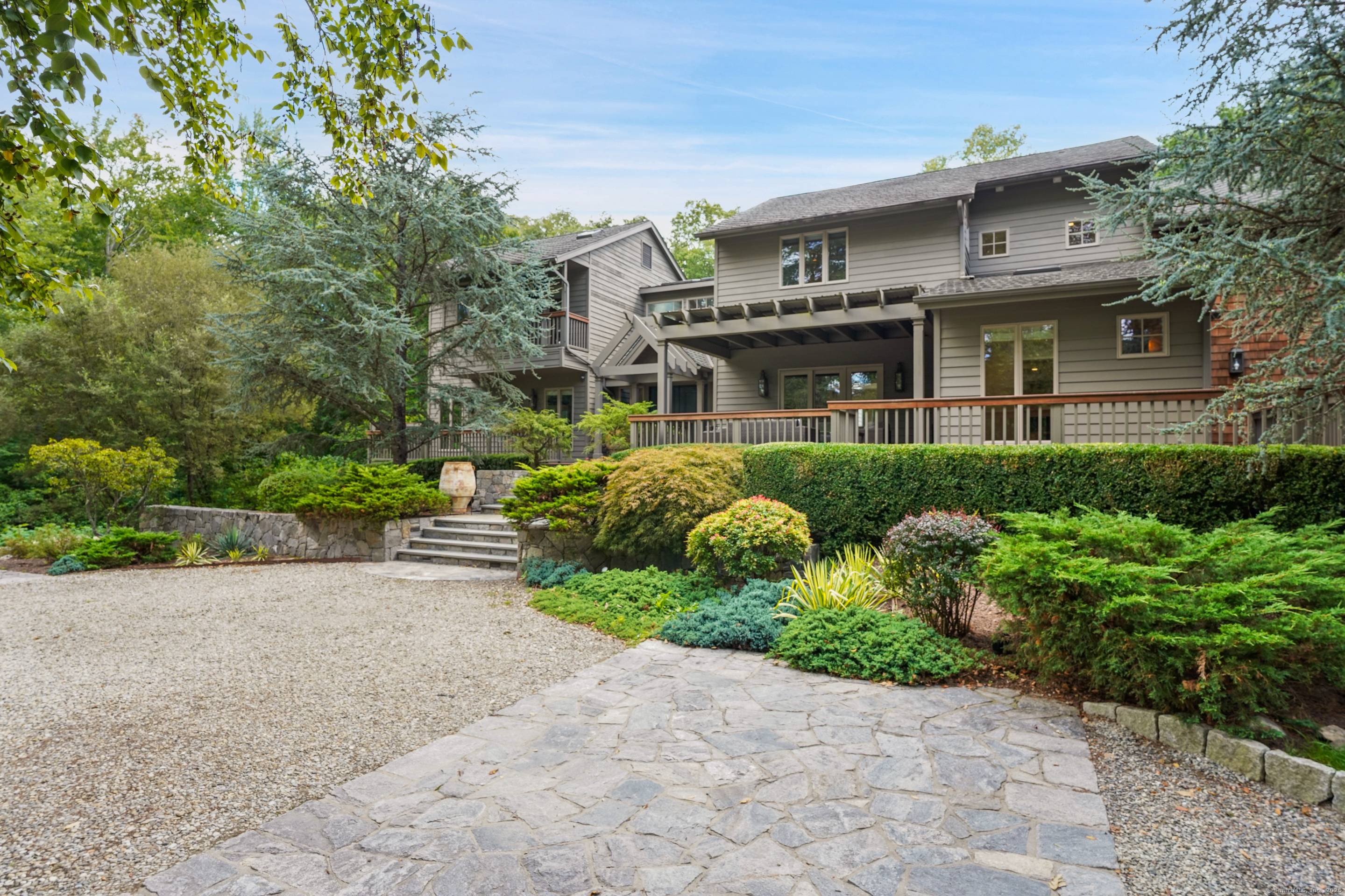 Set on more than two acres of exquisite, park like property in the coveted Red Coat estate section of Westport, this spectacular modern home with a glorious gunite pool offers ...