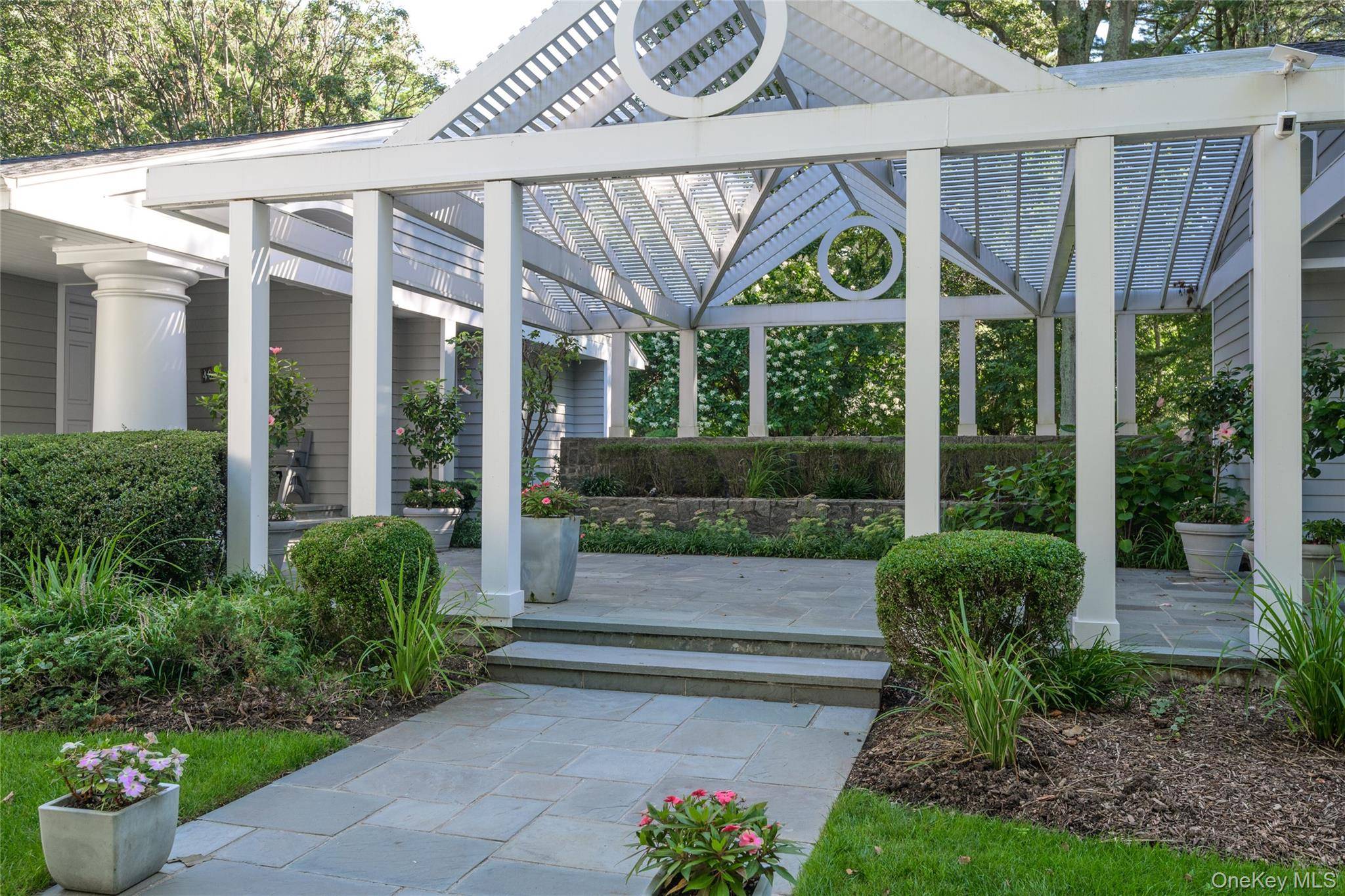 OLD WESTBURY MASTERPIECE Welcome to this magnificent 6000sqft Hamptons style residence set on two beautifully landscaped acres on a private cul de sac within the highly sought after Jericho School ...