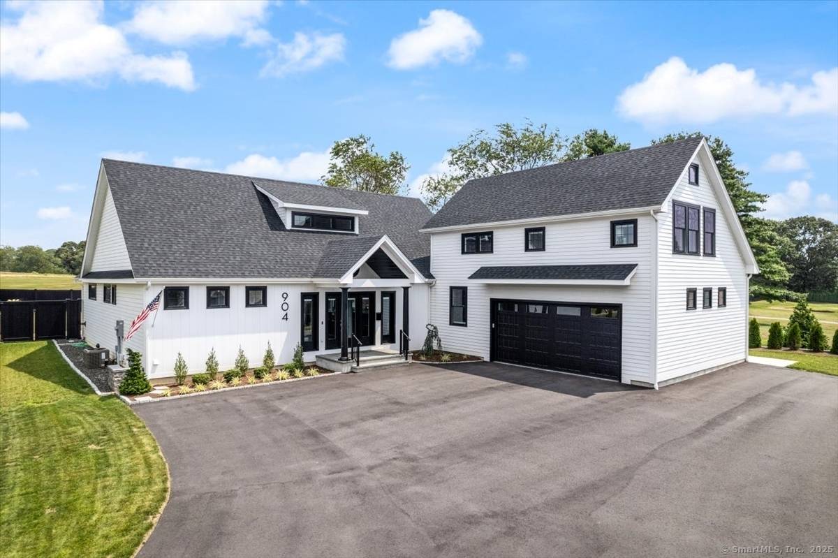 Modern luxury meets coastal charm in this stunning newly built custom home set directly on the picturesque Shennecossett Golf Course facing the 14th hole.