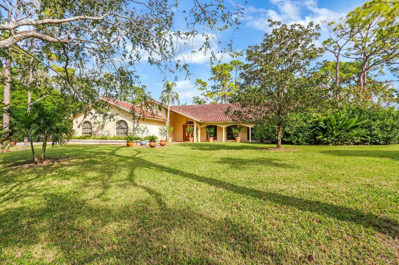 Discover 5 acres of equestrian charm in the highly sought after, gated community of Homeland.