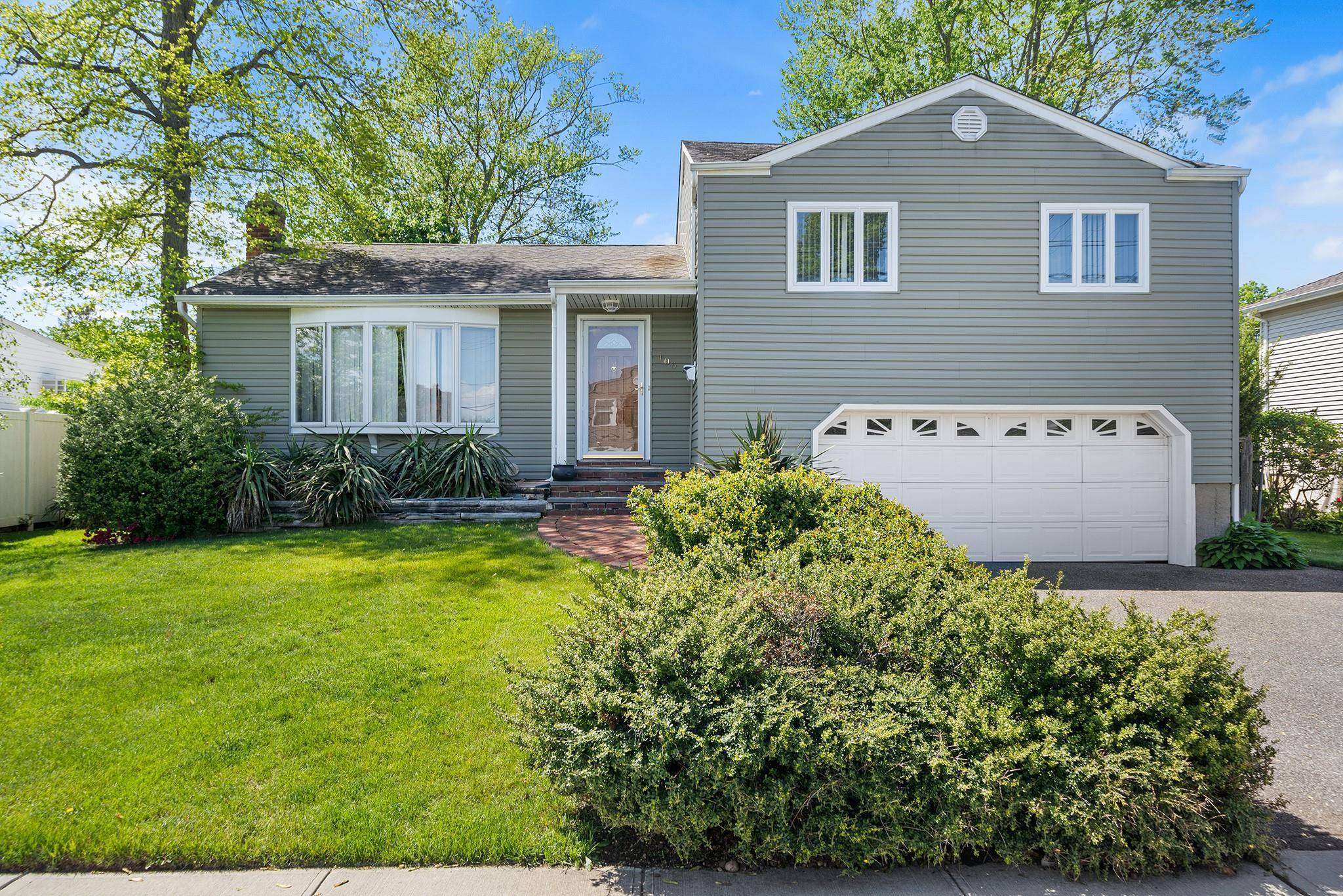 Deal fell through... Welcome to 105 Farmers Ave, a classic split level home in the heart of Plainview, offering timeless curb appeal and mature landscaping.