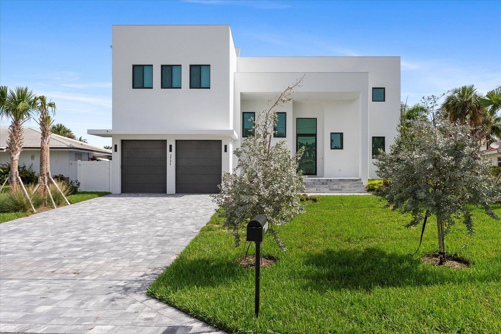 Impeccably designed and move in ready, this sunlit two story new construction offers elevated living with soaring ceilings, 4'x4' designer tiles, and motorized shades on the main level.