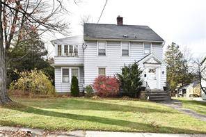 Charming 3 bedroom Colonial Inviting Vestibule entry built in seat with storage and coat hooks, hardwood floors, wide wood trim, and walk up attic.