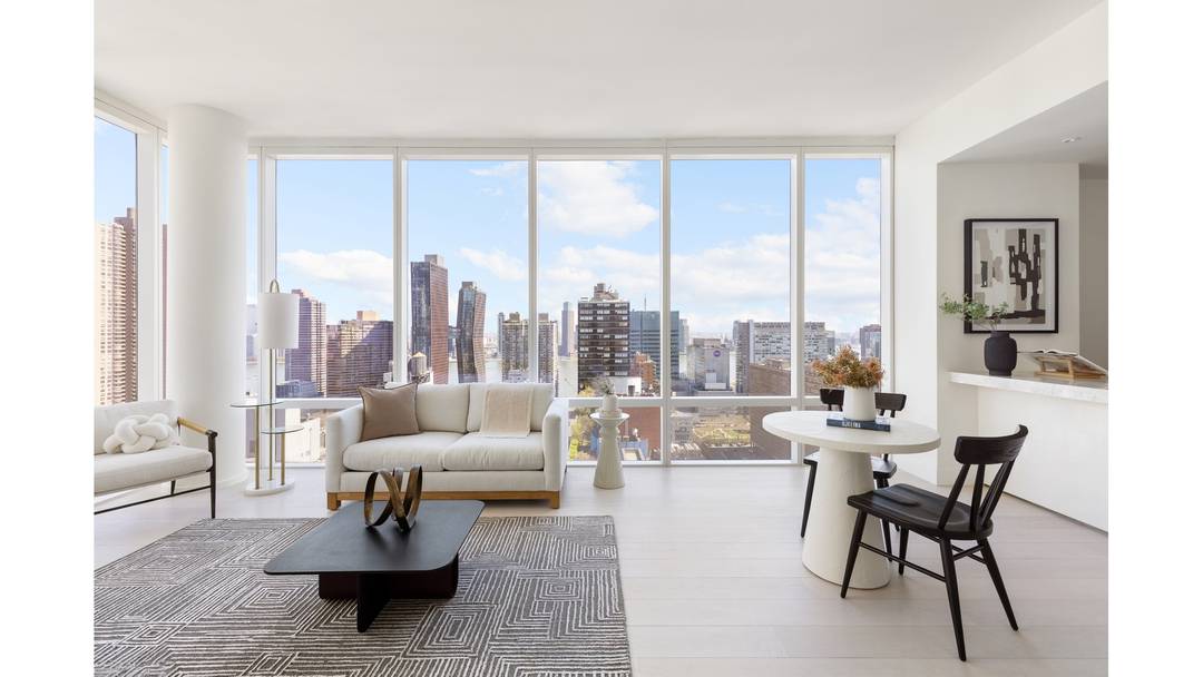 Luxury corner home with 10' floor to ceiling windows and expansive views of the River, Manhattan skyline and Long Island City.