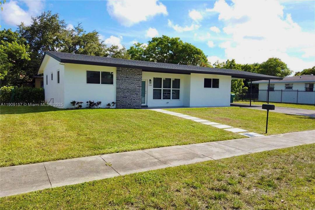 Beautifully remodeled home featuring impact windows and doors, new roof, updated plumbing and electrical, and a spacious carport for two cars.