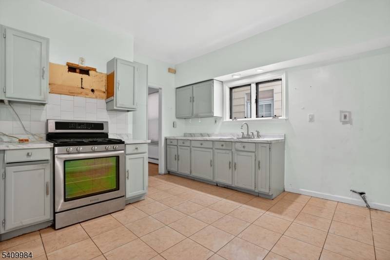 Exceptional Two family Home with Bonus Finished Attic ideal for Investment Spacious and versatile, this property features a total of 8 bedrooms and 3 full bathrooms across three levels.