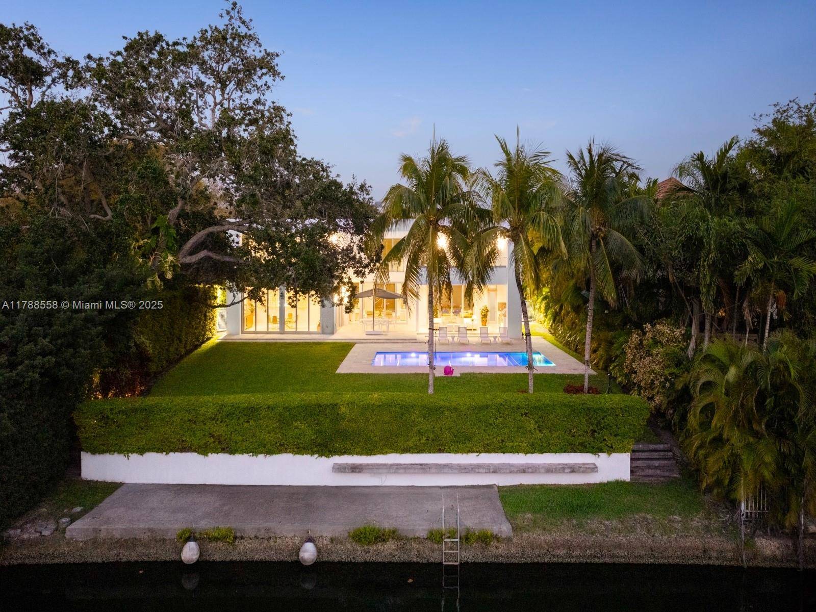 Exceptional waterfront residence with private dock on the Mahi Waterway offering direct access to Biscayne Bay.
