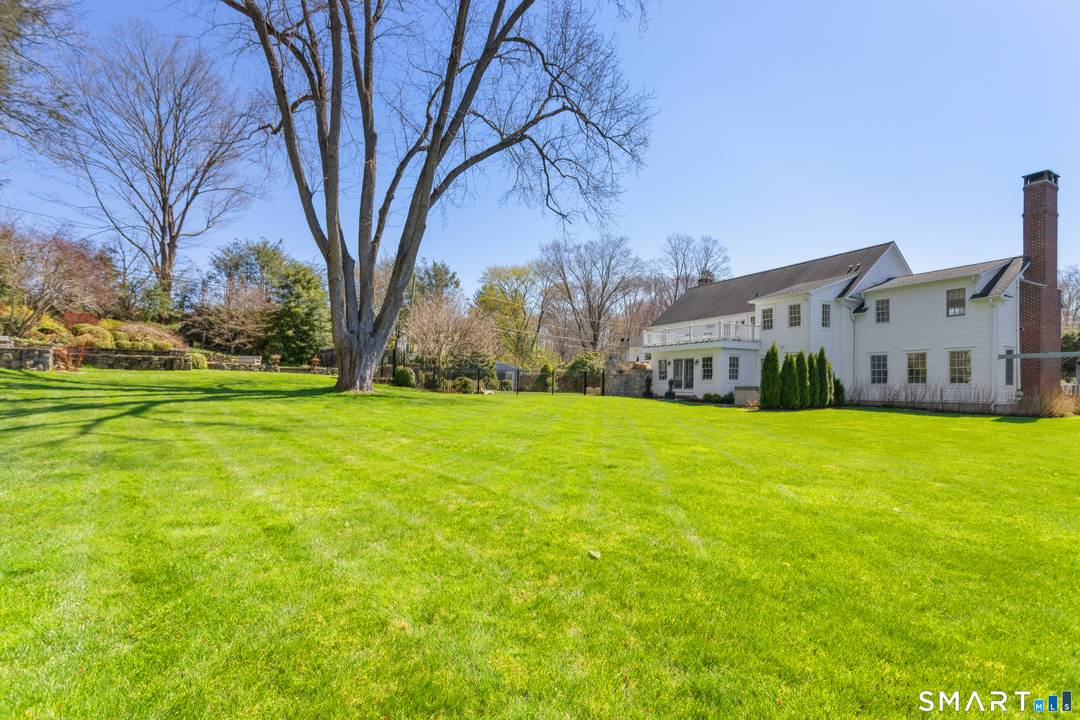 In Westport's coveted Long Lots neighborhood, this gracious and stately residence makes a striking first impression, set back from the road behind mature privacy trees and professionally landscaped grounds.