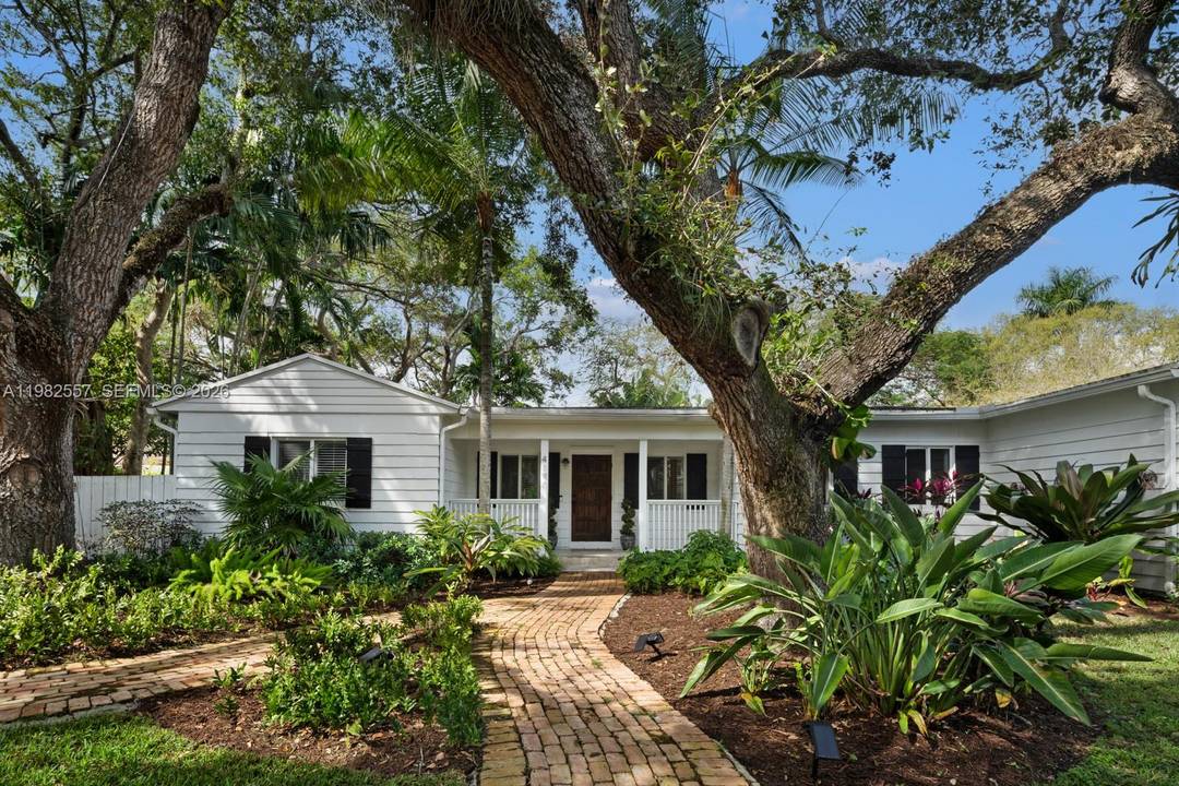 Nestled on a peaceful, tree lined street in South Coconut Grove, this charming corner lot home offers a perfect blend of tranquility and modern living.