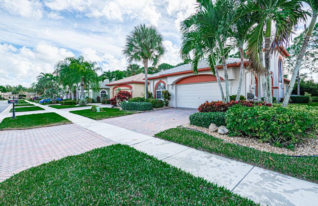 ABSOLUTELY METICULOUS RIVIERA MODEL WITH A FABULOUS SERINE SETTING SURROUNDING THE EXTENDED SCREENED PATIO.
