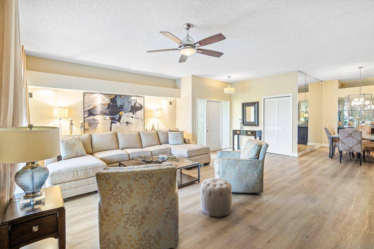 Gorgeous ground level condo boasting picturesque panoramic lake and golf views !