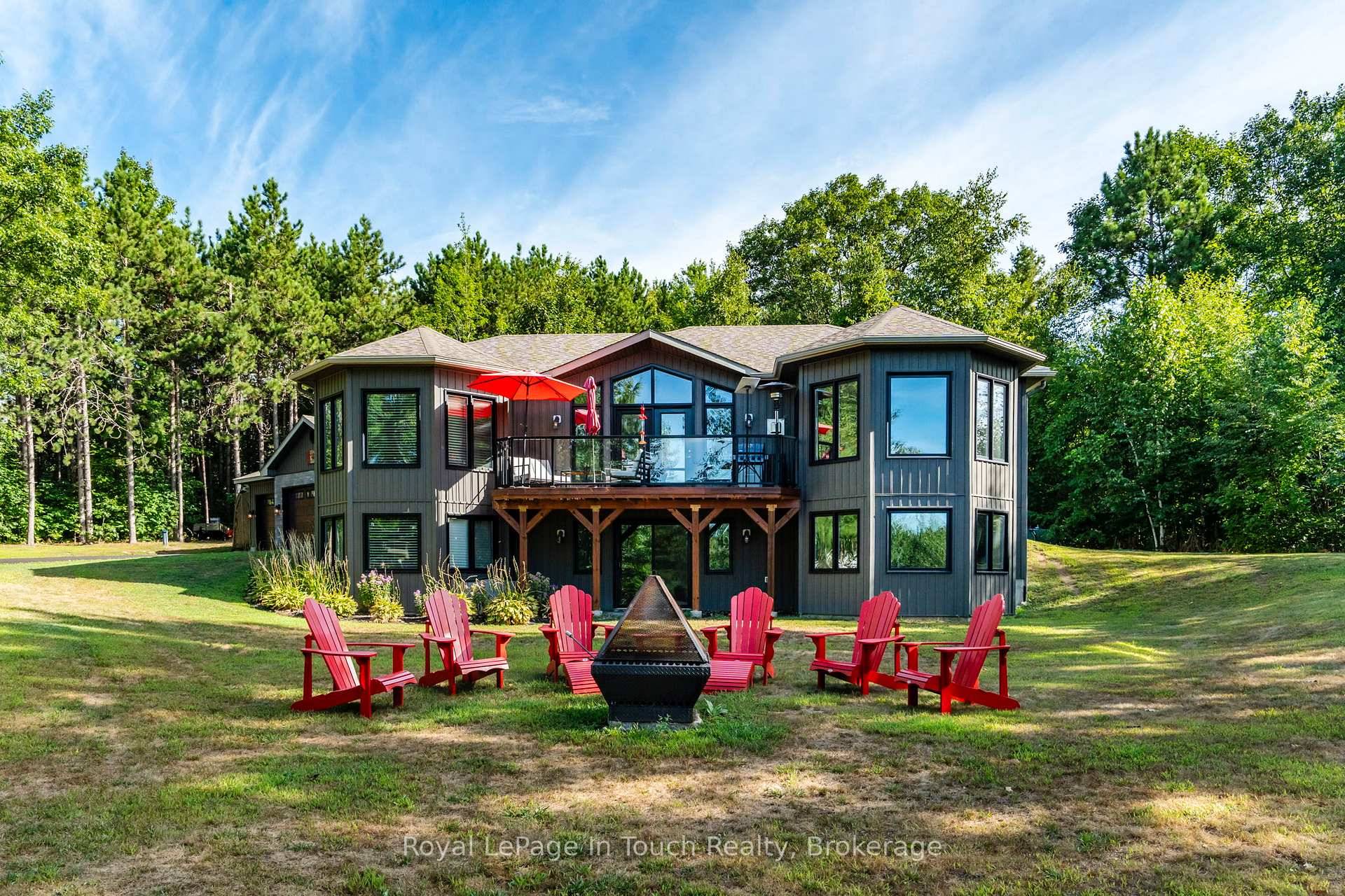 Private Location ! ! ! Exquisite home set on a 2 acrematured treed lot boasting phenomenal views and a large circular driveway with a triple car garage.