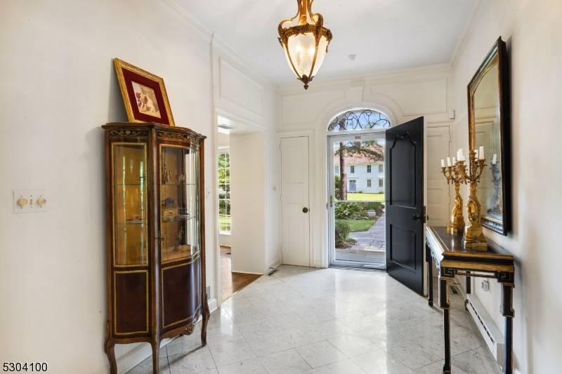 Discover this elegant French Country brick estate, nestled in the coveted Holmehill Section of Roseland, just 22 miles from New York City.