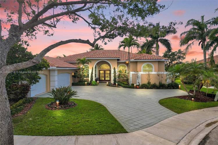 Spectacular one story completely remodeled home in the rarely available exclusive community of Edgewater at Weston Hills Country Club.