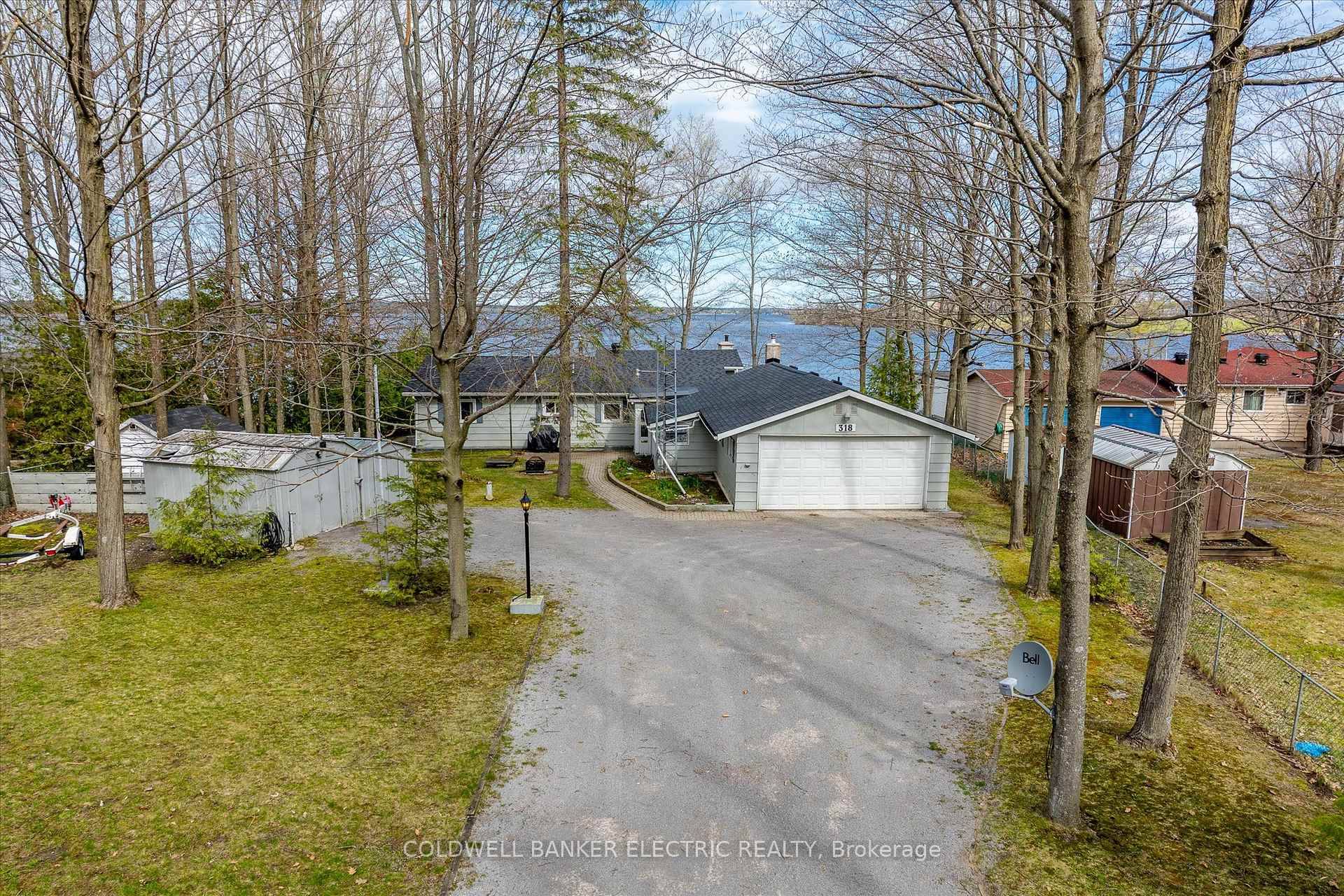 This is lakeside living at its finest think island vibes, but with year round road access, a full time home, and unforgettable sunsets thanks to the westerly views.