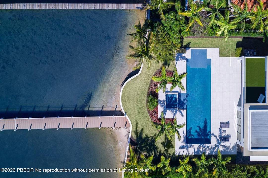 Experience refined, effortless living in this gorgeous waterfront estate nestled in the private enclave of Hypoluxo Island.