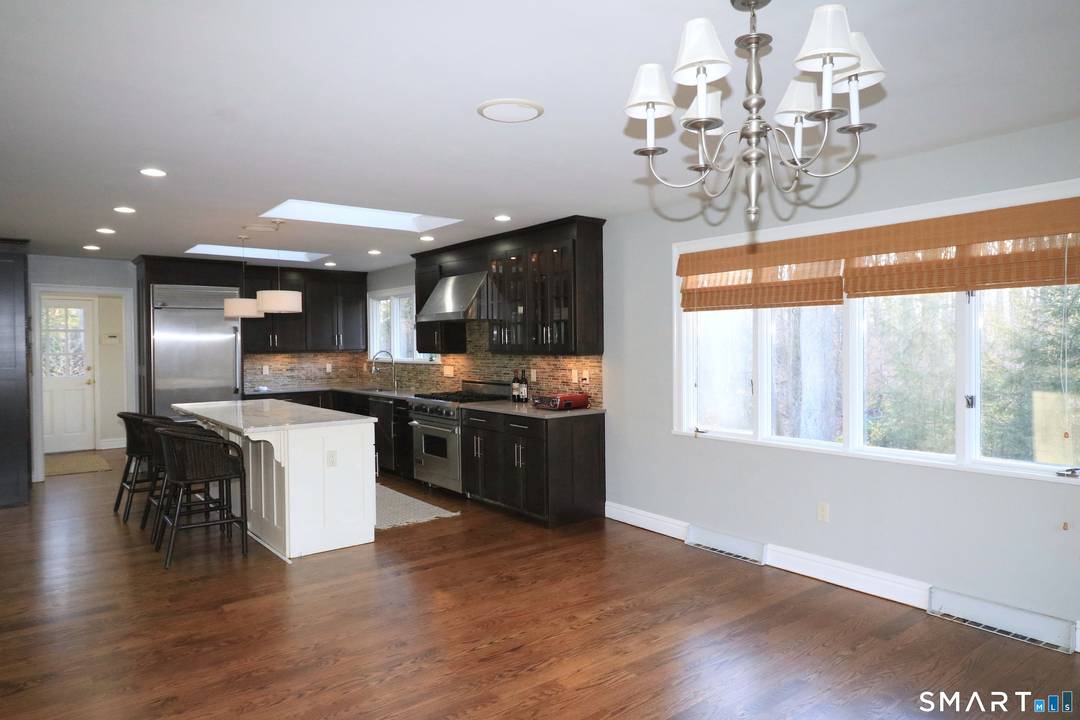 Stunning North Stamford California style ranch home on a secluded two acre wooded back lot.