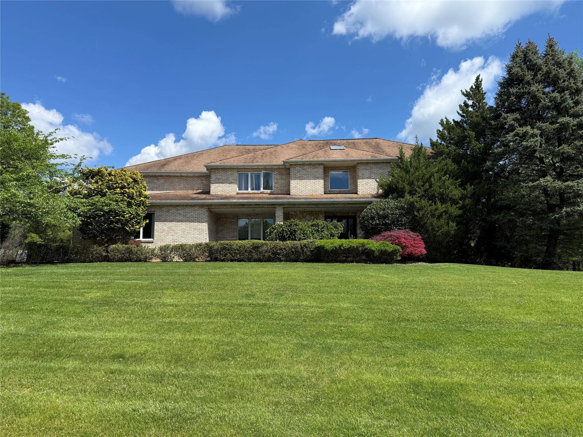 Beautiful Brick Contemporary Colonial in West Nyack on a level acre corner lot with views of Lake Deforest.