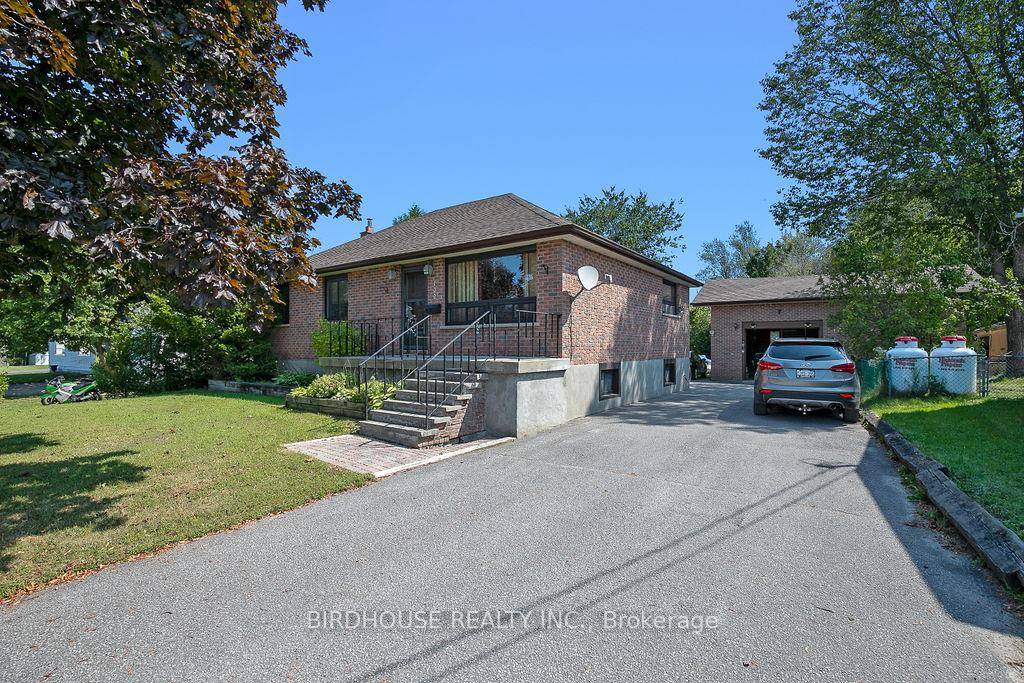 Three bedroom, two baths, solid brick raised bungalow with insulated, detached garage.