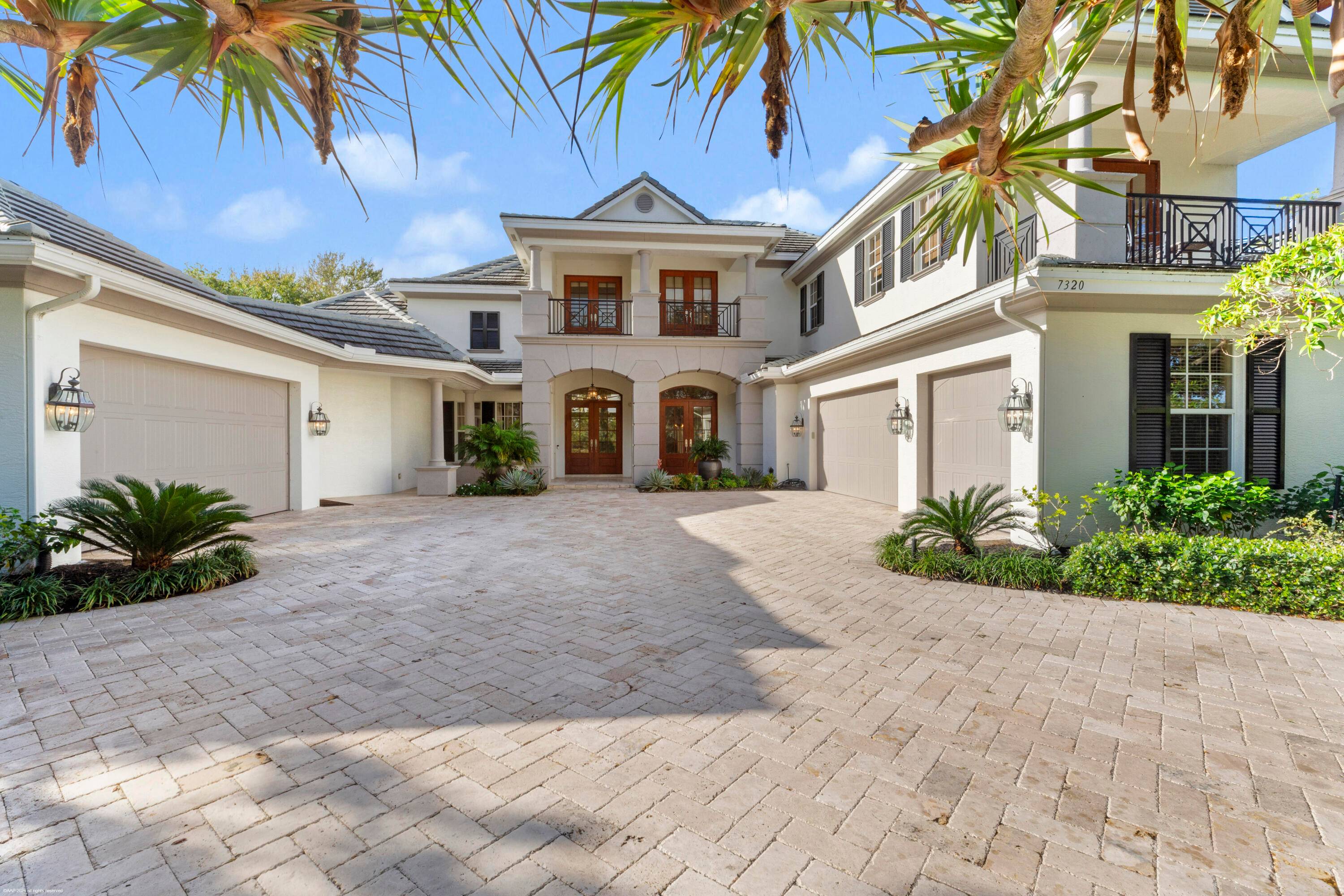 This stunning estate welcomes you through grand double mahogany doors into a space defined by soaring ceilings and vast windows that frame serene views of the pool, golf course, and ...